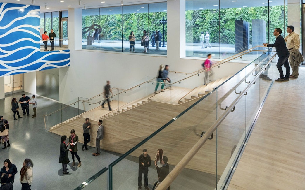 Visitors inside San Francisco Museum of Modern Art with modern architecture and art displays.