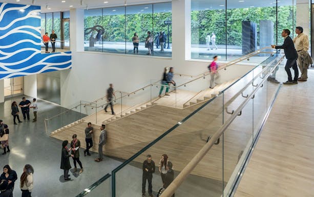 Visitors inside San Francisco Museum of Modern Art with modern architecture and art displays.