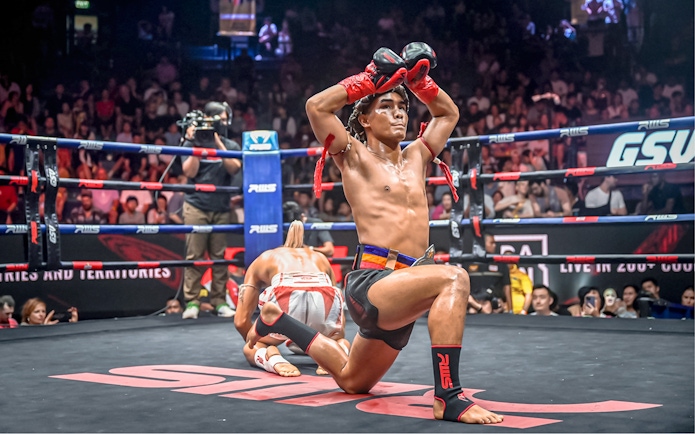 Muay Thai fighters performing pre-fight ritual at Rajadamnern Boxing Stadium.