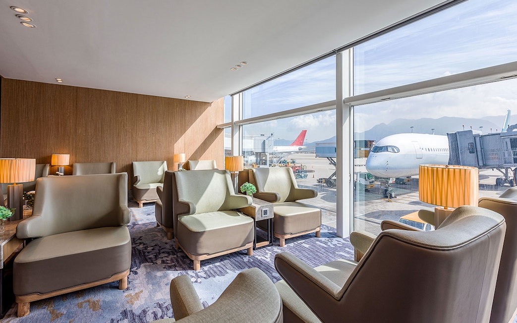 Plaza Premium Lounge seating area with airport runway view.