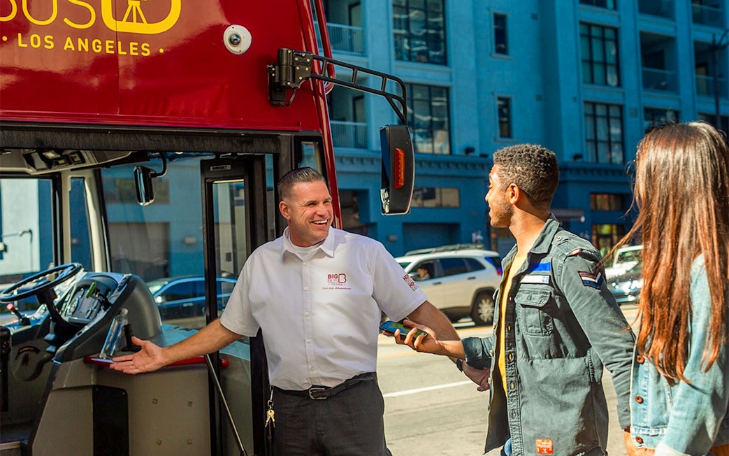 Tourists boarding a Los Angeles double-decker bus for the Hop-On Hop-Off Tour near Hollywood Walk of Fame.