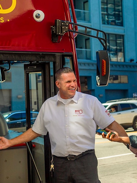 Tourists boarding a Los Angeles double-decker bus for the Hop-On Hop-Off Tour near Hollywood Walk of Fame.