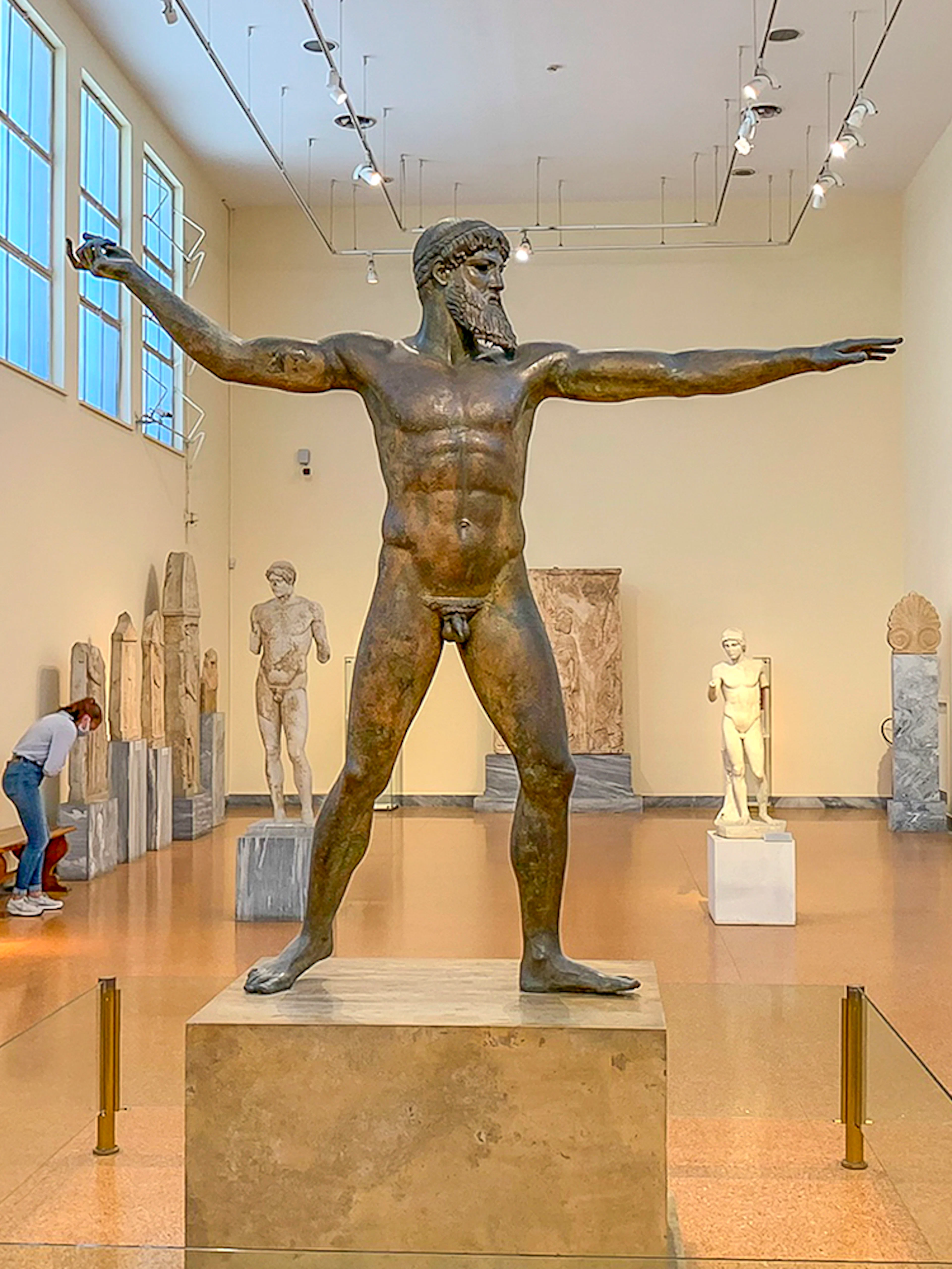 Guests viewing ancient sculptures inside National Archaeological Museum.