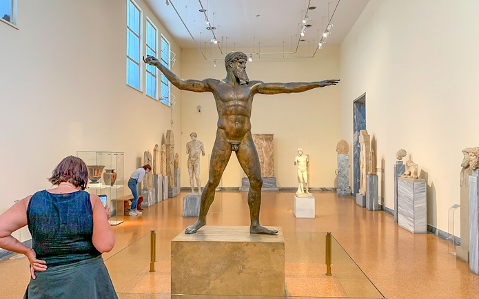 Guests viewing ancient sculptures inside National Archaeological Museum.