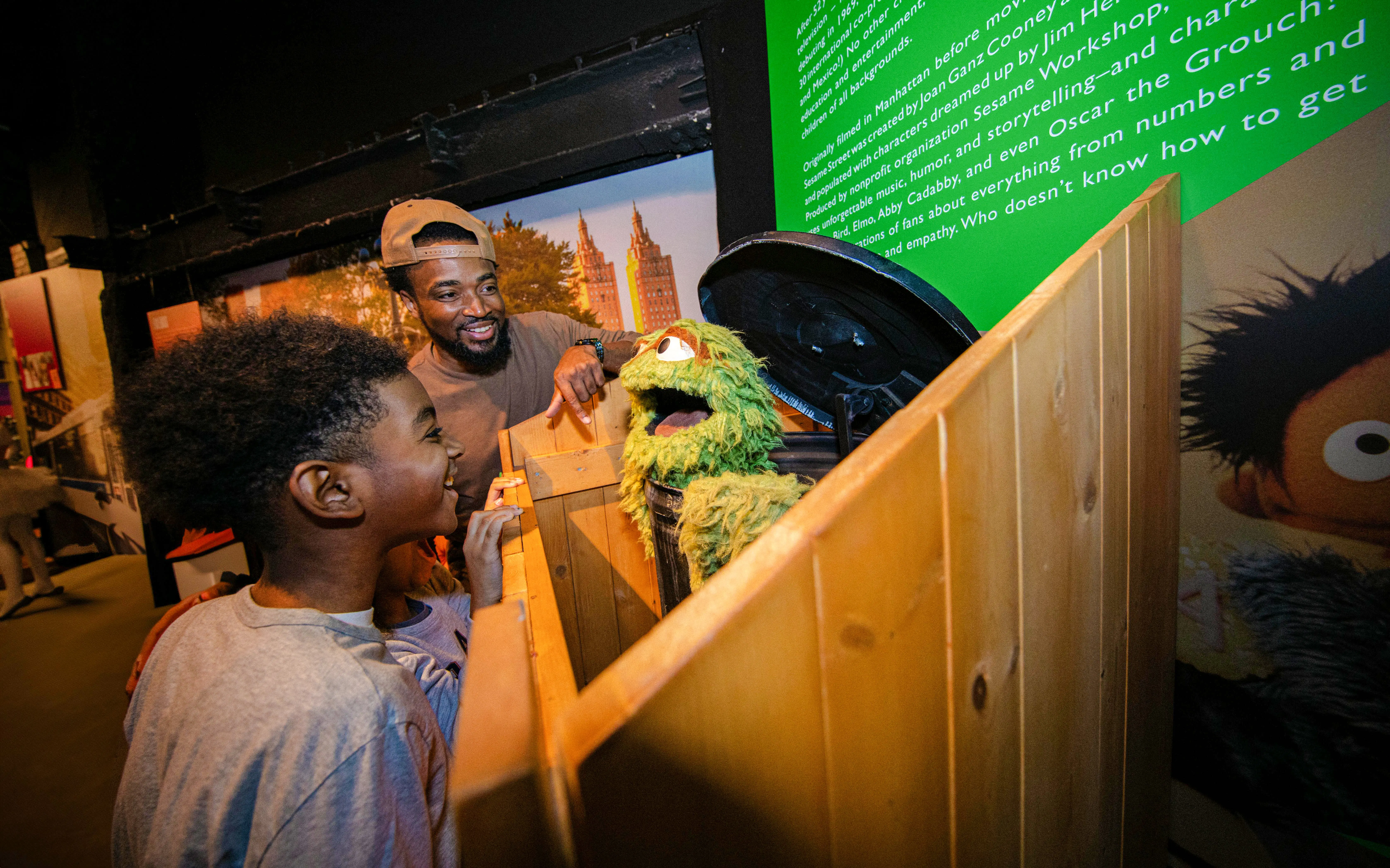 Guests interacting with a puppet exhibit inside RiseNY.