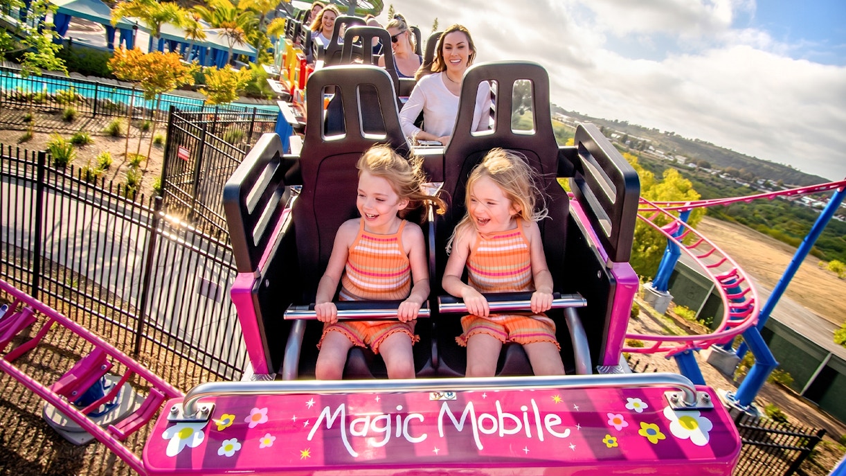 Children enjoying a roller coaster ride at Sesame Place San Diego.