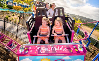 Children enjoying a roller coaster ride at Sesame Place San Diego.