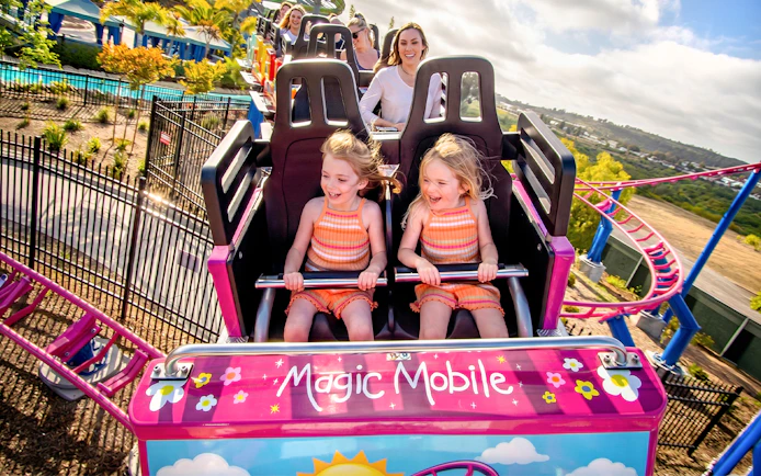 Children enjoying a roller coaster ride at Sesame Place San Diego.