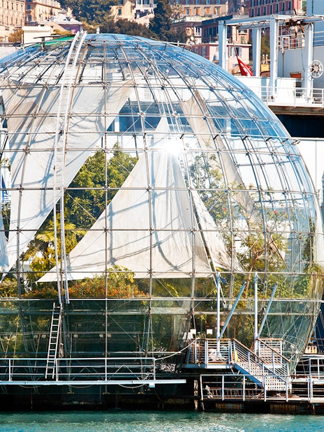 Genoa Aquarium Biosphere glass dome with plants inside, located by the waterfront.
