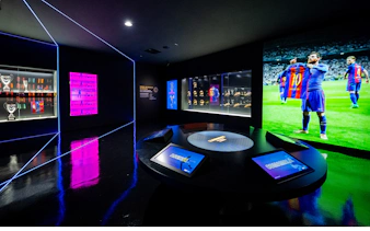 Camp Nou Barca Museum exhibit with trophies and player memorabilia.