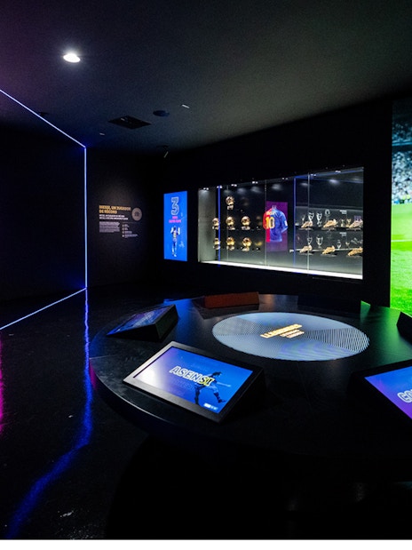 Camp Nou Barca Museum exhibit with trophies and player memorabilia.