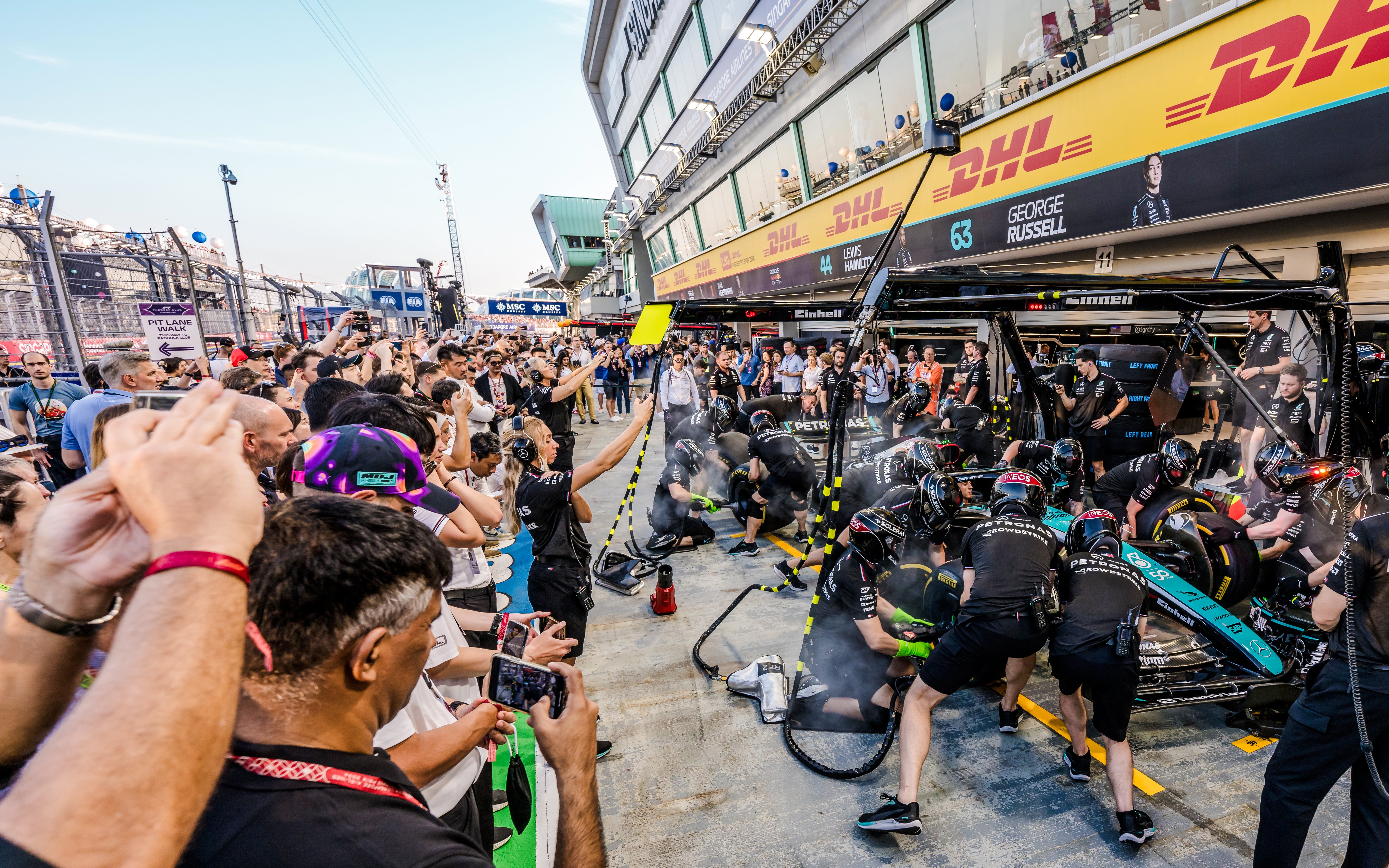 Crowd watching a Formula 1 pit crew during an exclusive Pit Lane Walk.