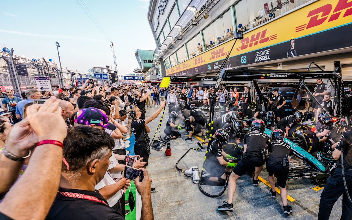 Crowd watching a Formula 1 pit crew during an exclusive Pit Lane Walk.