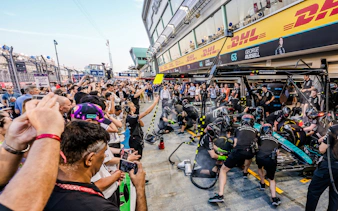 Crowd watching a Formula 1 pit crew during an exclusive Pit Lane Walk.