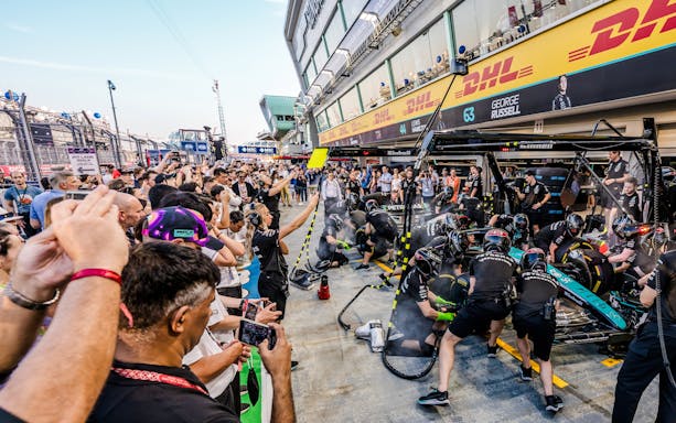 Crowd watching a Formula 1 pit crew during an exclusive Pit Lane Walk.