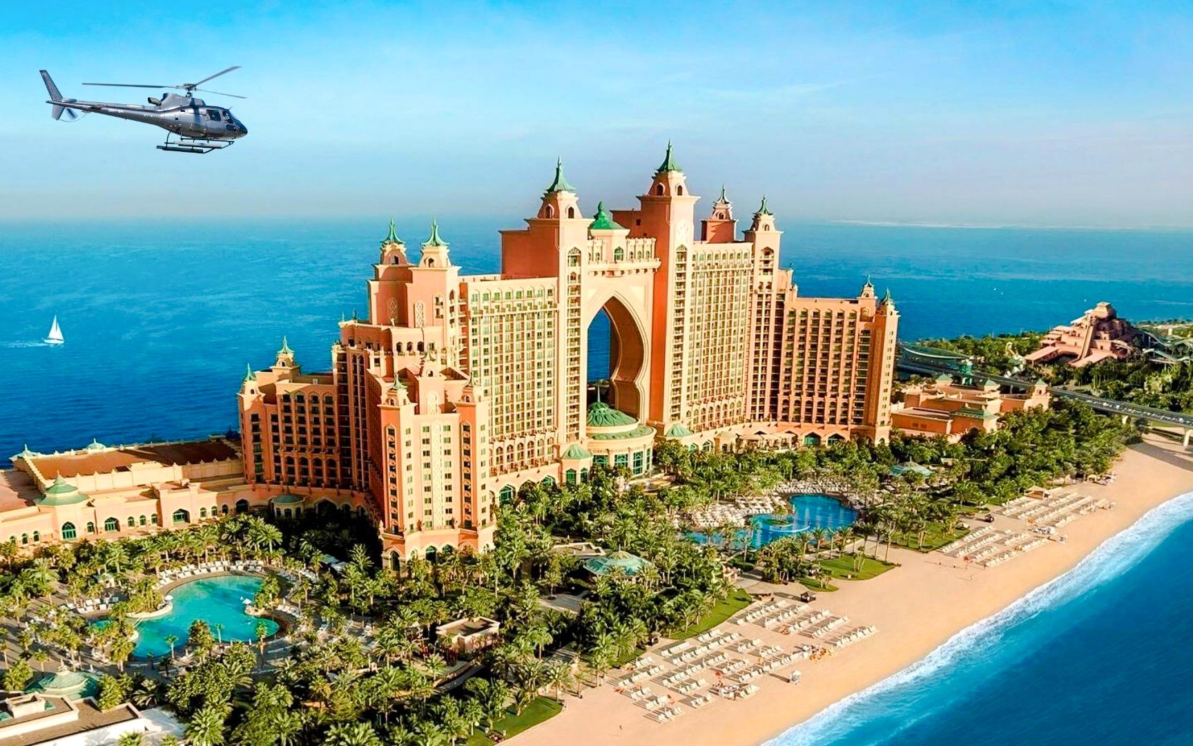 Helicopter flying over Atlantis, The Palm in Dubai with ocean view.