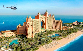 Helicopter flying over Atlantis, The Palm in Dubai with ocean view.
