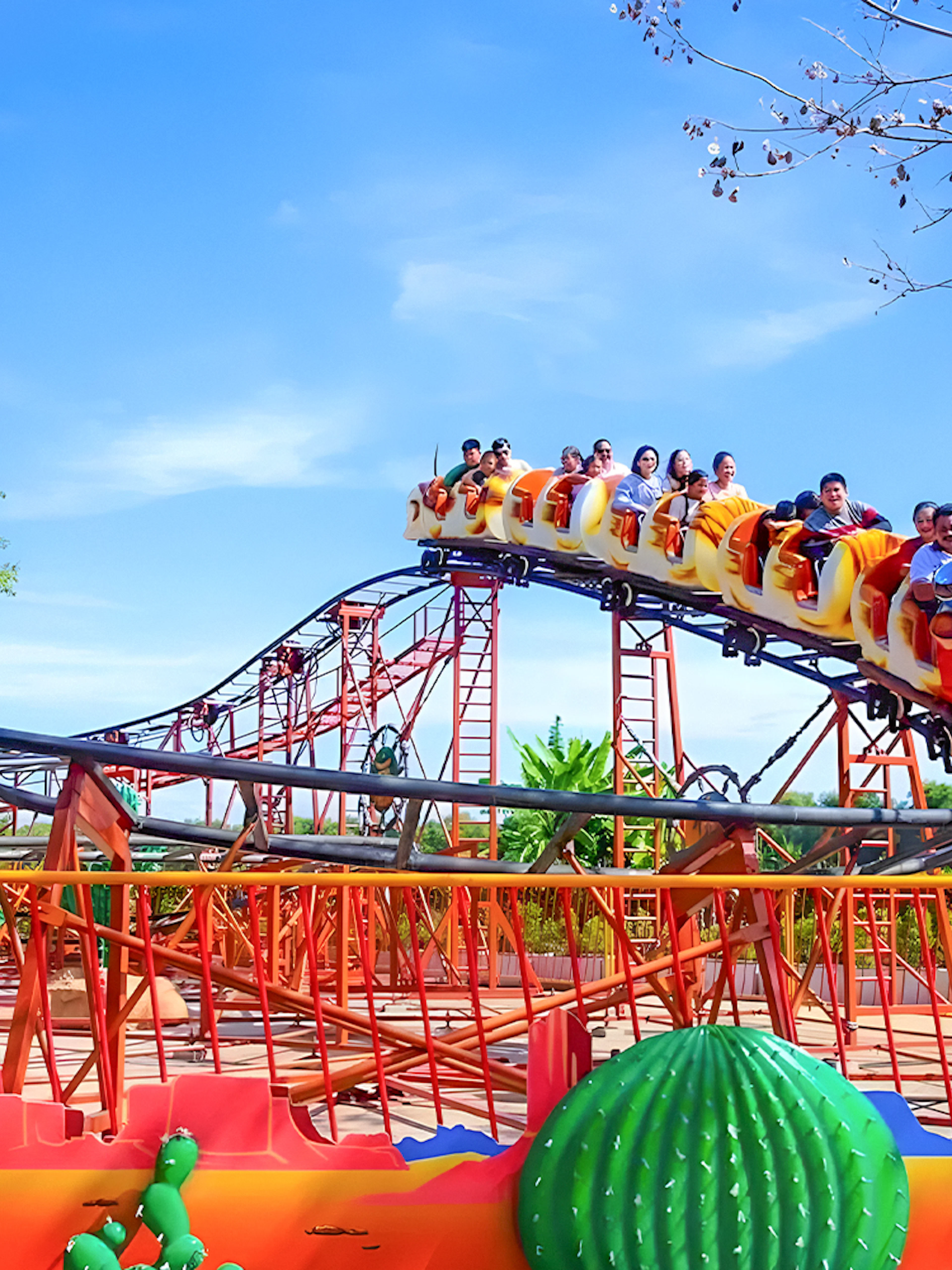 Roller coaster with passengers at Dream World Bangkok.