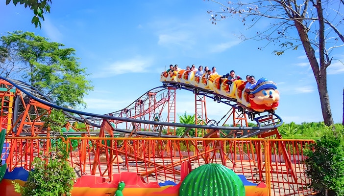 Roller coaster ride at Dream World Bangkok with vibrant park scenery.