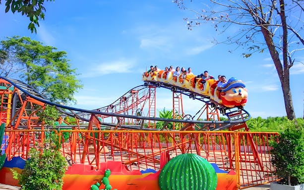 Roller coaster with passengers at Dream World Bangkok.