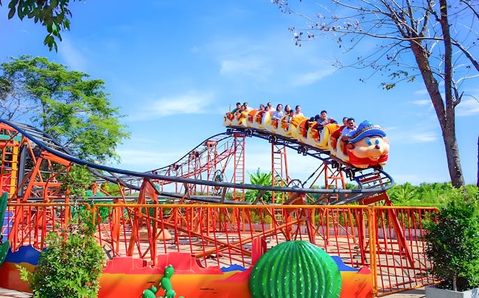 Roller coaster with passengers at Dream World Bangkok.
