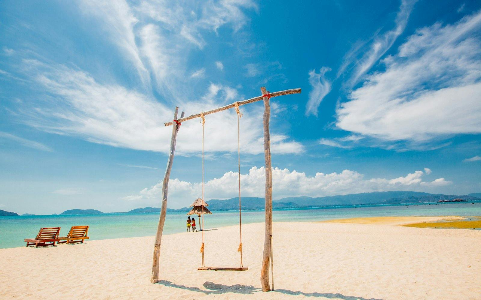 Swing on sandy beach at Koh Samui Pig Island with ocean view.