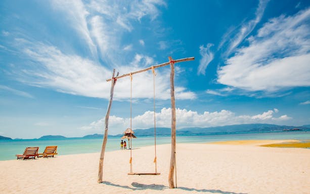 Swing on sandy beach at Koh Samui Pig Island with ocean view.