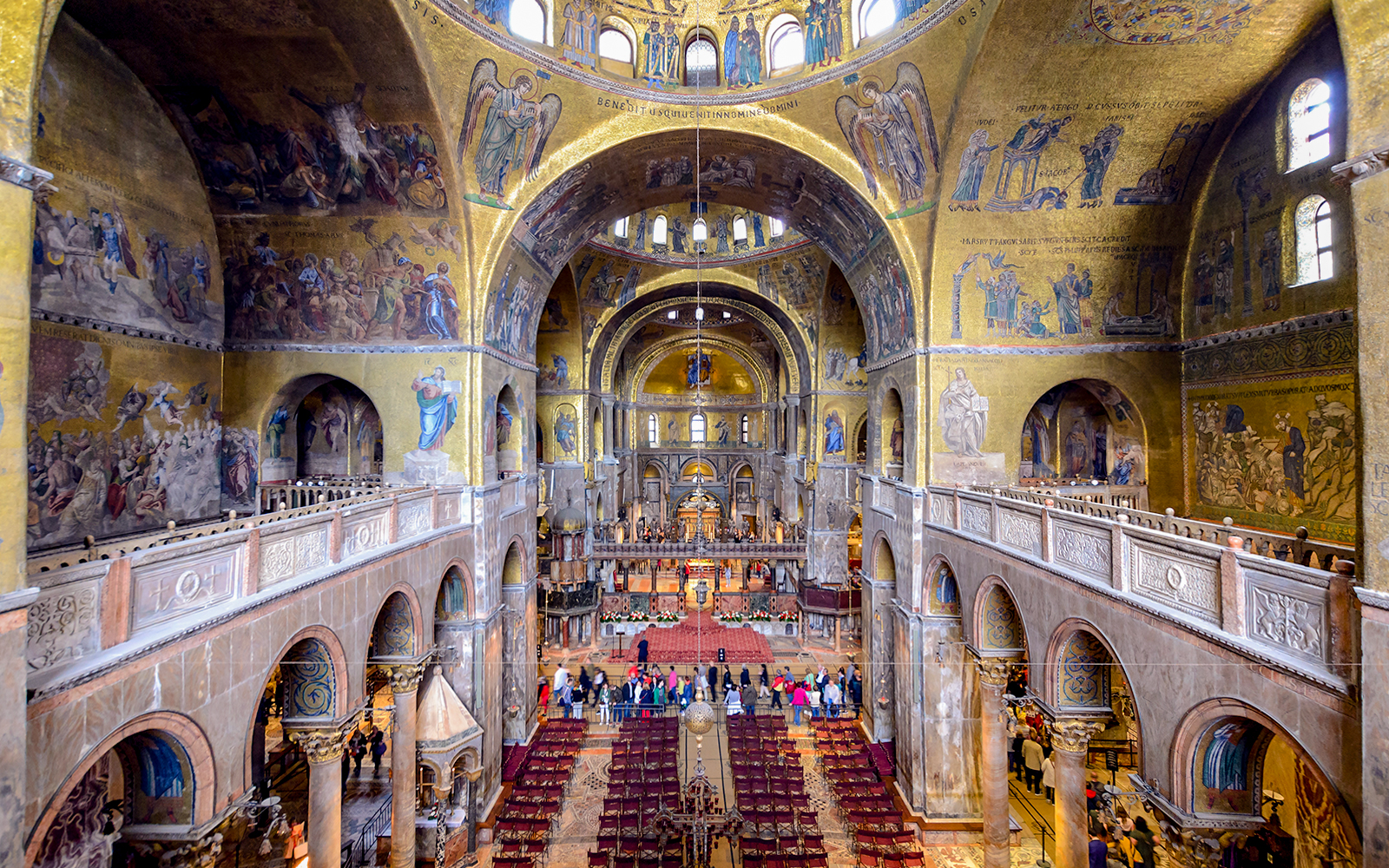 Interior of St Mark's Basilica in Venice, showcasing ornate mosaics and architectural details.