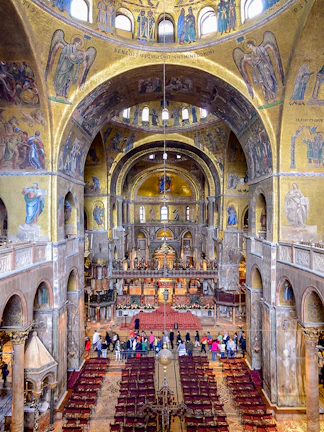 Interior of St Mark's Basilica in Venice, showcasing ornate mosaics and architectural details.