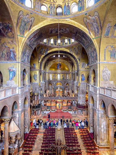 Interior of St Mark's Basilica in Venice, showcasing ornate mosaics and architectural details.
