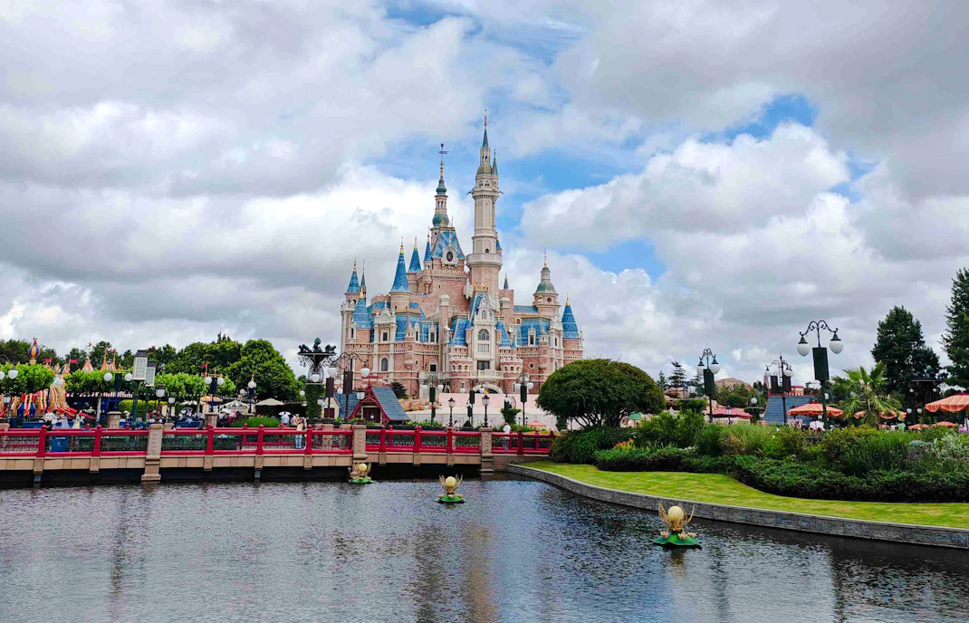 Shanghai Disneyland castle with surrounding gardens and waterway.