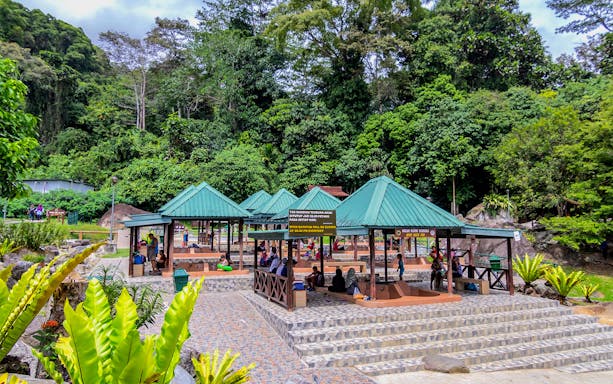 Pavilions at Mount Kinabalu park entrance surrounded by lush greenery.