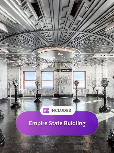 Empire State Building observatory interior with viewing binoculars and cityscape decor.