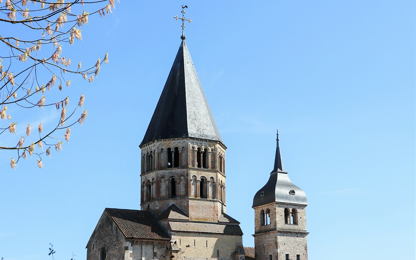 Abbaye de Cluny towers under blue sky, Lyon, France.