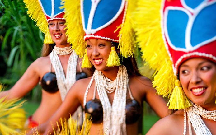 Hula dancers performing at Smiths Family Garden Luau in traditional attire.