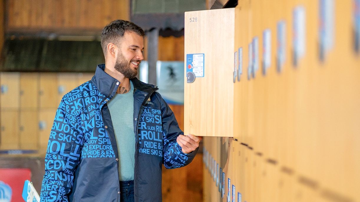 Man using locker at Ski Dubai Penguin Encounter.