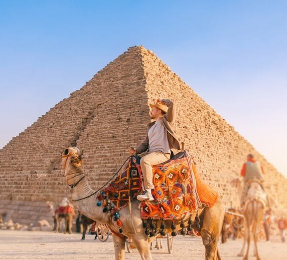 Camel ride in front of the Pyramid of Khafre at the Giza Complex, Egypt.