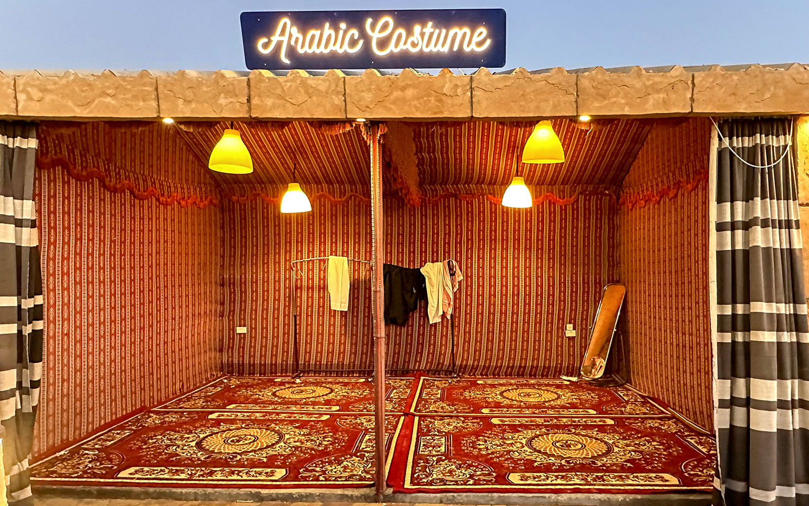 Arabic costume tent setup for private group desert safari experience.