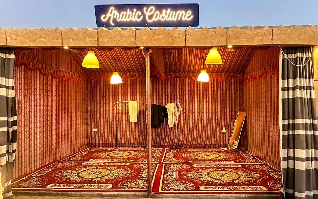 Arabic costume tent setup for private group desert safari experience.