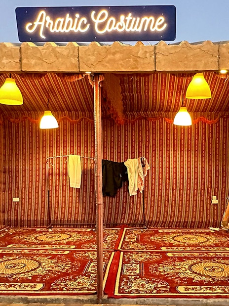 Arabic costume tent setup for private group desert safari experience.