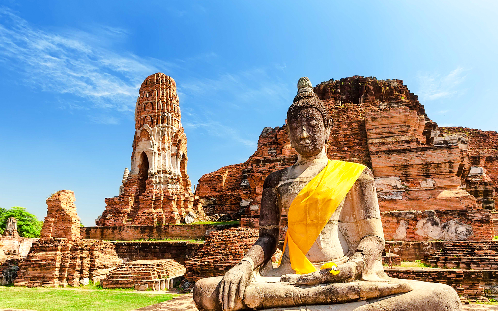 Buddha statue and ancient temple ruins at Ayutthaya Historical Park, Thailand.