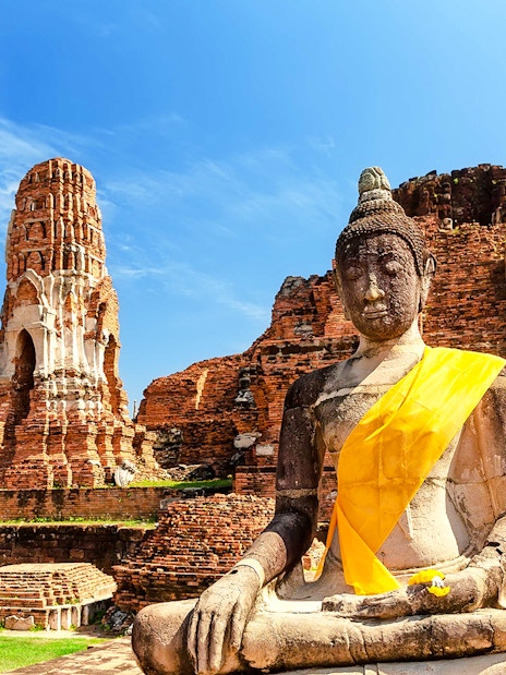 Buddha statue and ancient temple ruins at Ayutthaya Historical Park, Thailand.