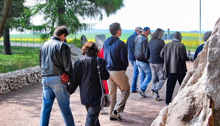 Group walking through Somme battlefields on a day trip from Paris.