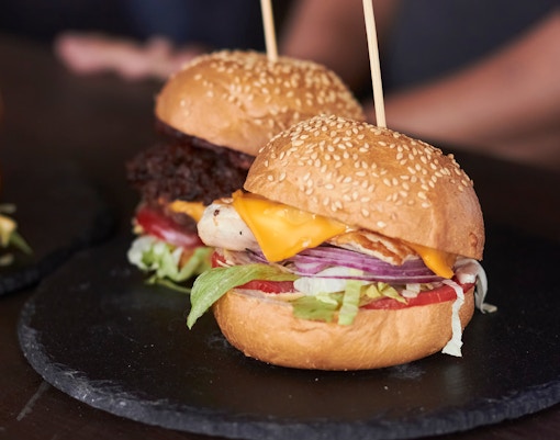 Burgers with cheese and vegetables at Disney Village Paris restaurant.
