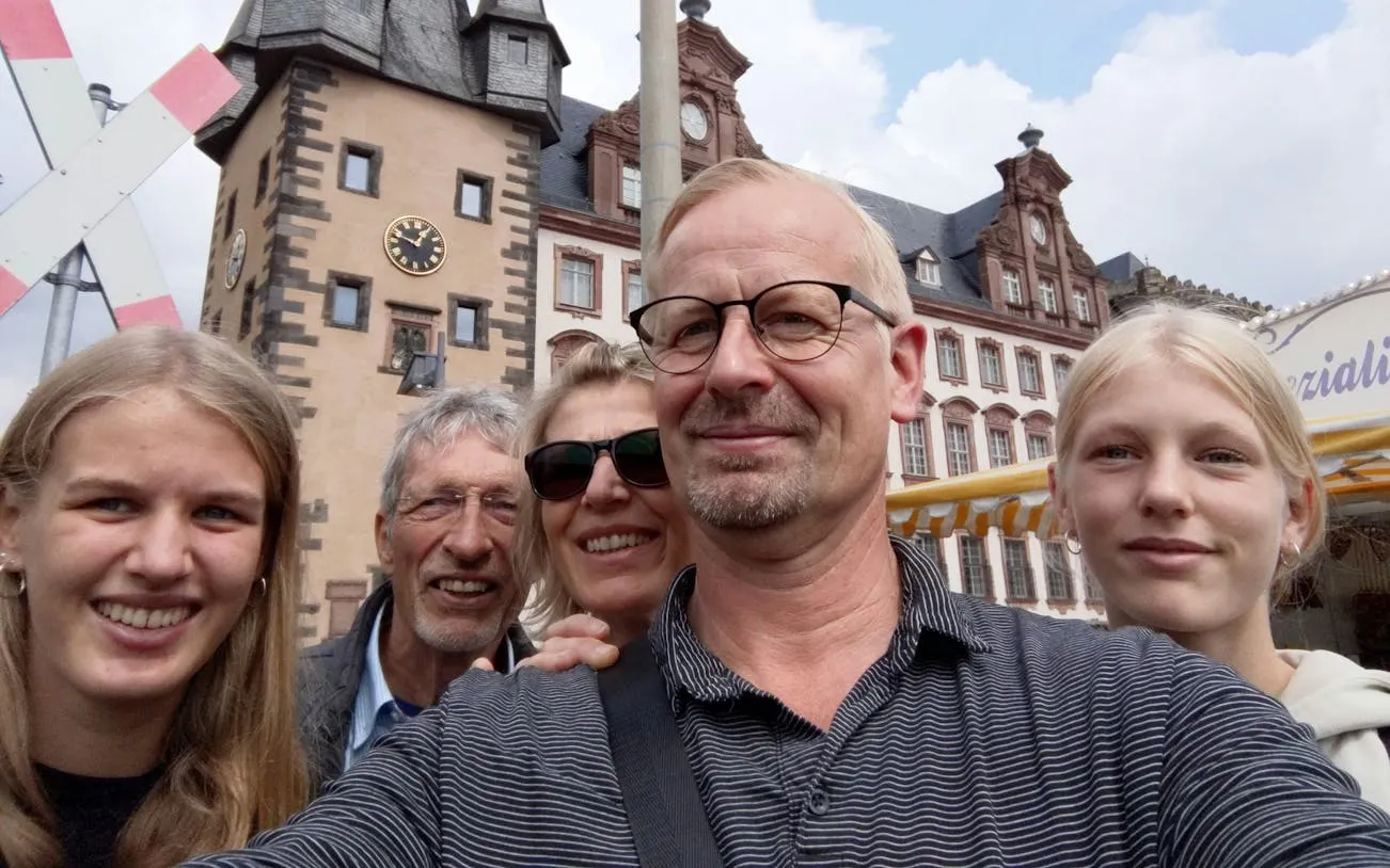 Group enjoying Old Town Frankfurt with historic buildings in the background.