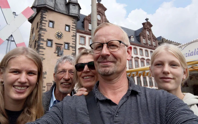Group enjoying Old Town Frankfurt with historic buildings in the background.