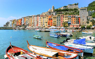 Colorful buildings and boats in the harbor of Portovenere, Cinque Terre.