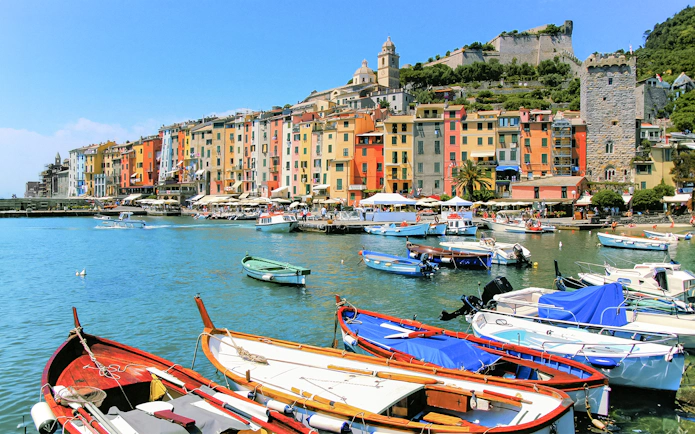 Colorful buildings and boats in the harbor of Portovenere, Cinque Terre.