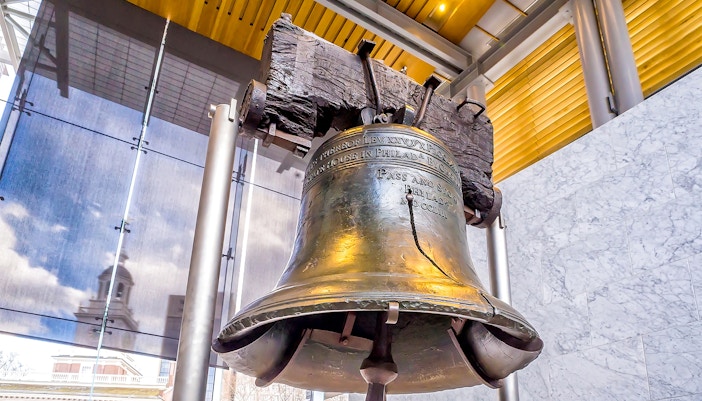 Liberty Bell in Philadelphia's Independence Hall with city view.