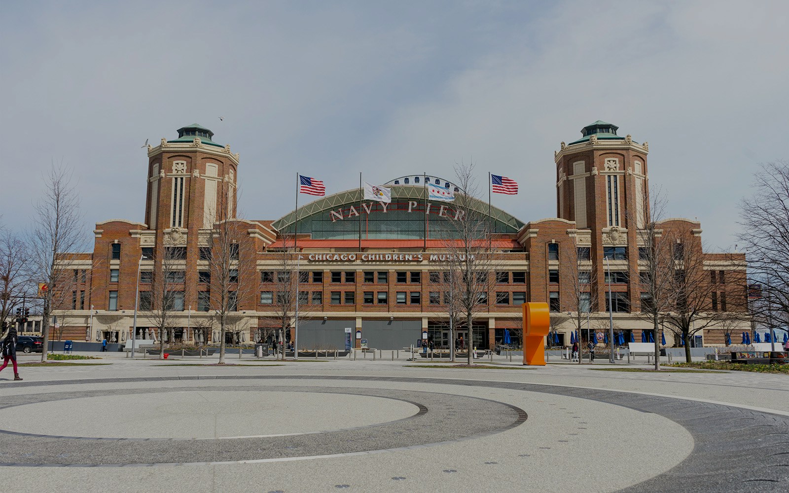 Navy Pier in Chicago with Centennial Wheel and boats docked nearby.